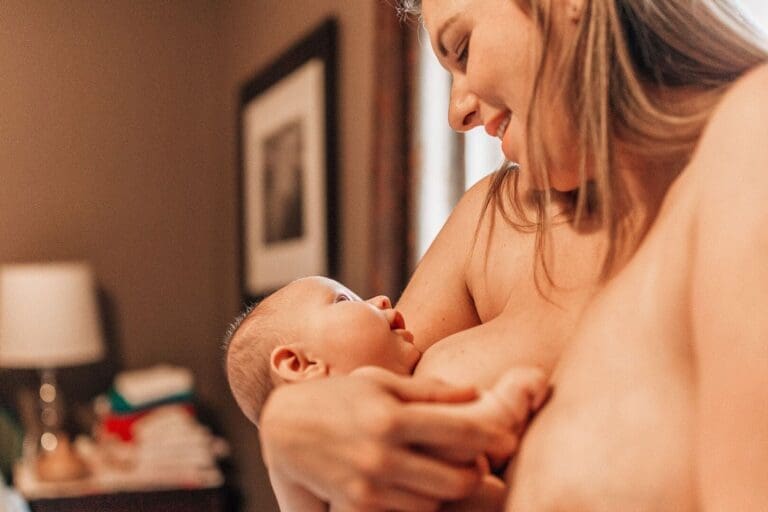 breastfeeding a distracted baby while he's looking up at his mom